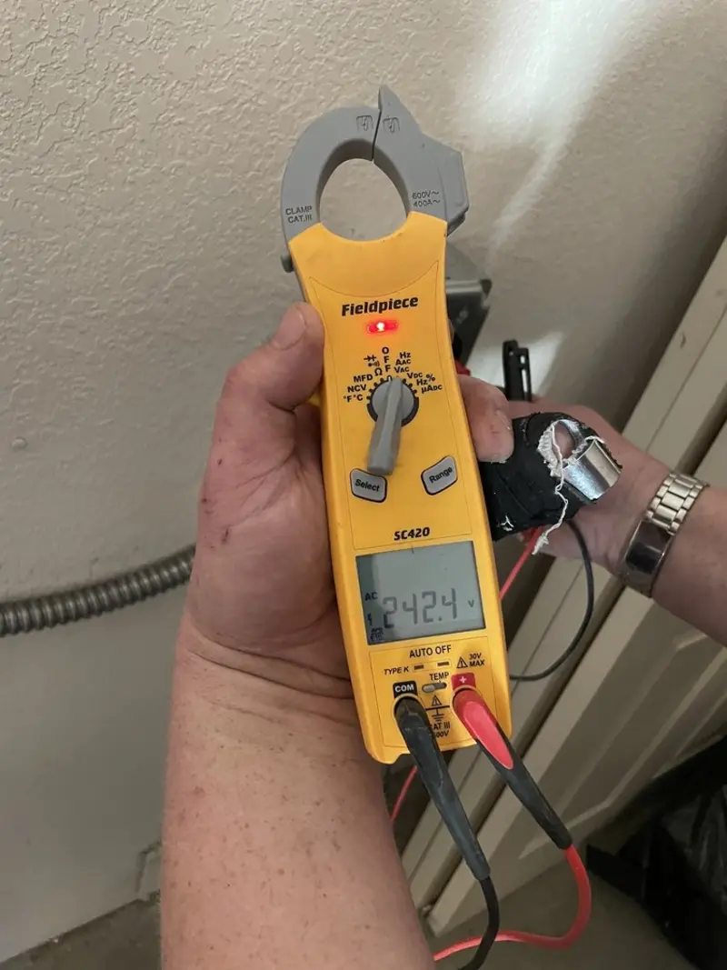 Voltage testing with clamp meter during Whole House Surge Protector in London